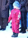 Little girl in winter dress, listening to the trombone concert